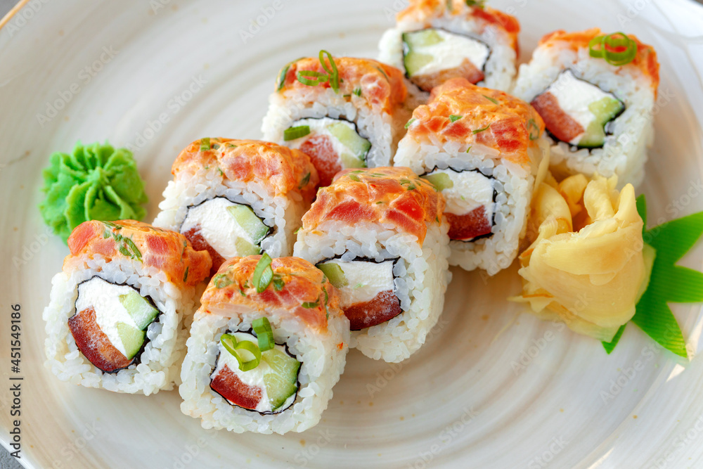 Japanese sushi roll with salmon on plate Japanese sushi roll with salmon on plate