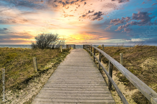 Path to the Baltic beach made of wood with dunes and cloudy sky