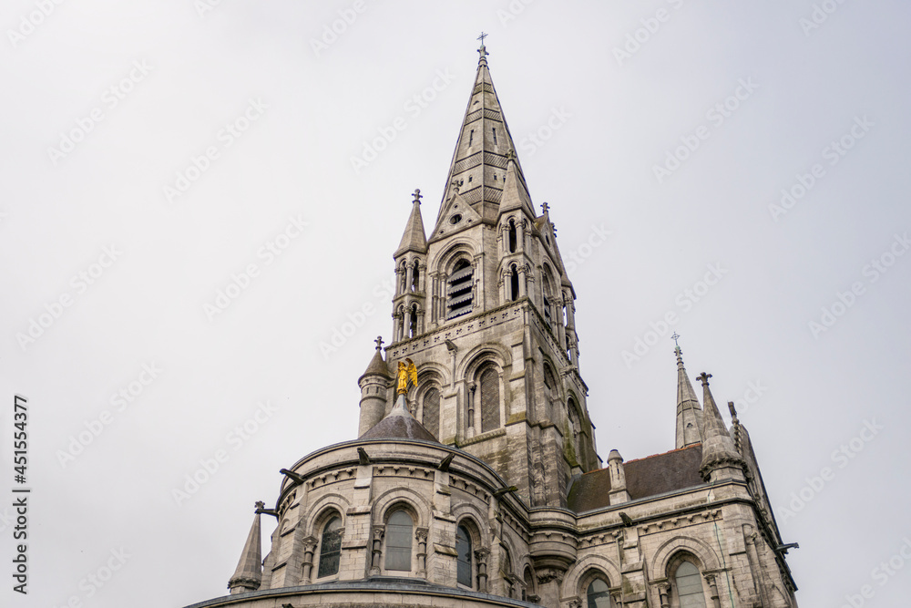 towers and golden angel of the cathedral of Cork in the south of ireland a typical gray day of the country