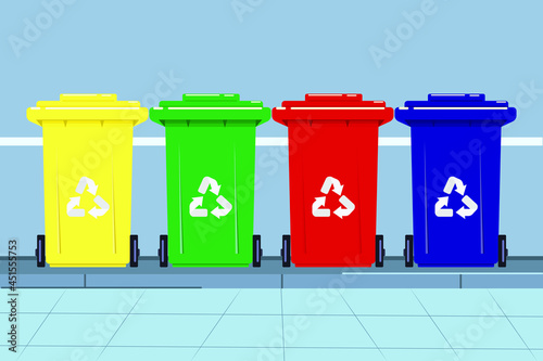 plastic trash Four colorful recycling bins separated on the street in front of the house,
 red, yellow, green and blue bins with recycle waste symbol. front view of four plastic 
recycling bins  flat 