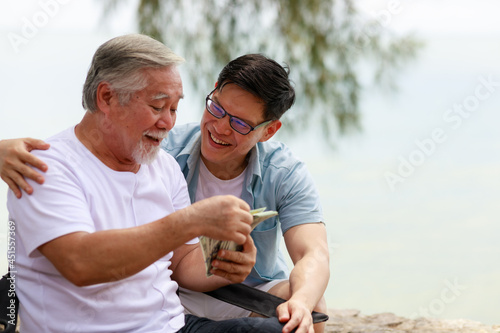 A man give money to his father.Financial and saving concept.