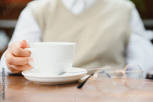 female hands holding a cup of coffee