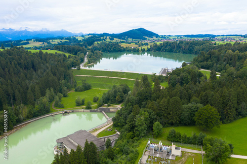 Panorama drone view over Forggensee lake with the dam. The lake located north of Fussen in the district of Ostallgau in Bavaria, Germany. Tourism and vacations concept.