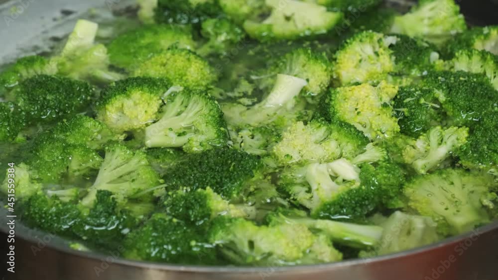 Pieces of broccoli in boiling water. Cooking the vegetables for healthy dish at kitchen. Pieces of broccoli in boiling water. Cooking the vegetables for healthy dish at kitchen.