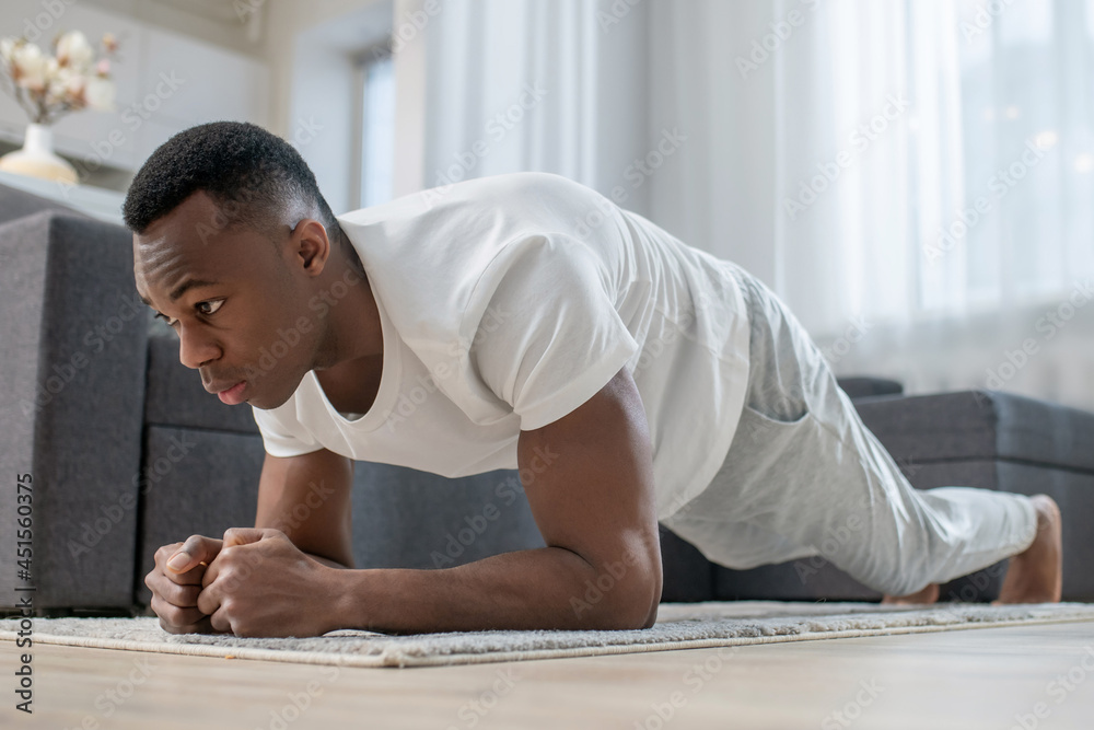 African american guy in white clothes doing morning exercises African american guy in white clothes doing morning exercises