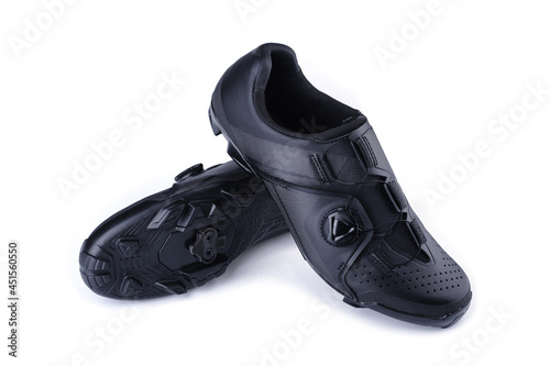 A pair of black cycling MTB shoes isolated on white background. Studio shot