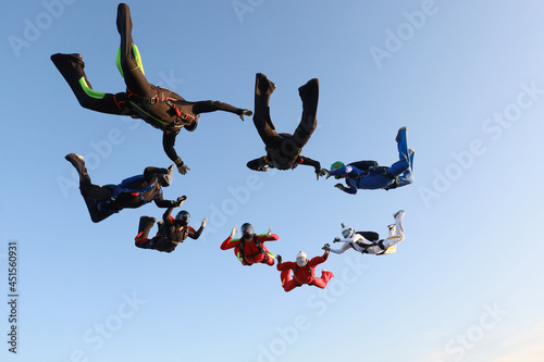 Skydiving. A team of skydivers is in the sky.