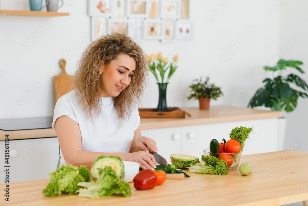 Young woman preparing vegetable salad in her kitchen. Healthy lifestyle concept beautiful woman with mixed vegetable. Young woman preparing vegetable salad in her kitchen. Healthy lifestyle concept beautiful woman with mixed vegetable.