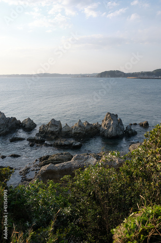 Vertical shot of the Sagami Bay from the rocky Morito Coast in Japan photo