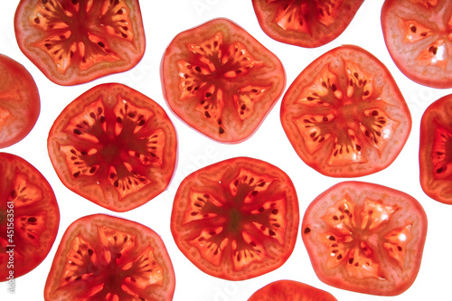 round tomato slices on white background