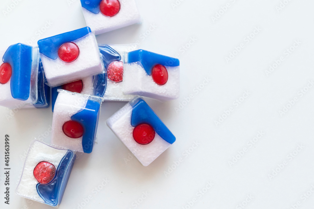 Dishwasher tablets, on white background with utensils Dishwasher tablets, on white background with utensils
