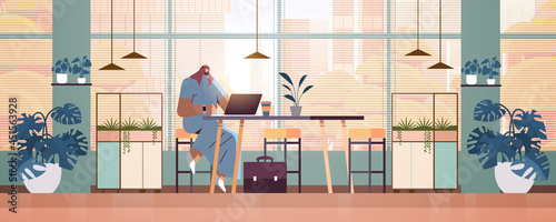 arab businessman sitting at workplace arabic business man freelancer working in creative office horizontal