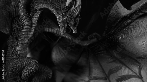 The figure of a fabulous grim dragon with raised wings and a curved neck