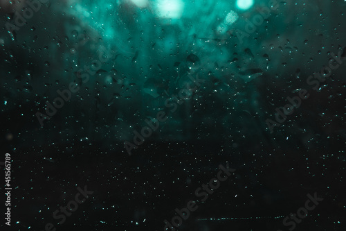 drops of water on a dark glass. Abstract background. Dark and moody © Serhii