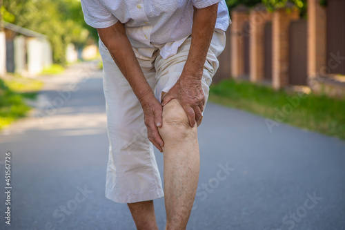 The grandmother has an old woman knee pain. Selective focus. photo