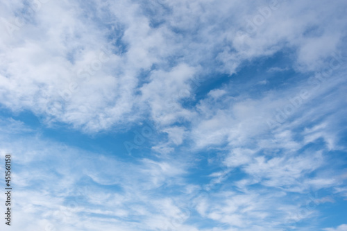 Cirrus clouds in the blue sky,beautiful Cirrus uncinus in the blue summer sky. Background of blue sky and white feathery clouds