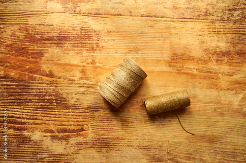 two spools of twine on a wooden table, sewing, twine