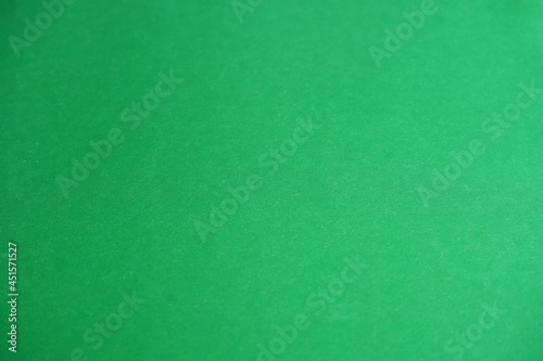 Green background. The texture of the cardboard.