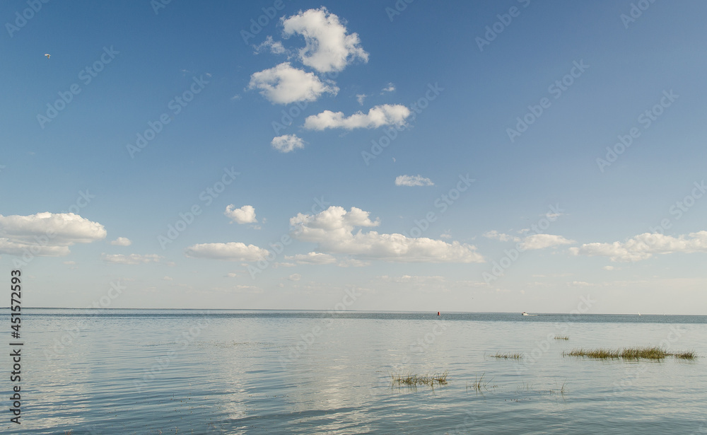 Big lake with clouds in sunny summer day, Lithuania.
