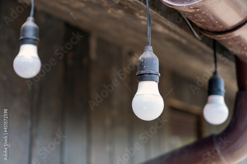 Street light bulbs in a spider web under the roof