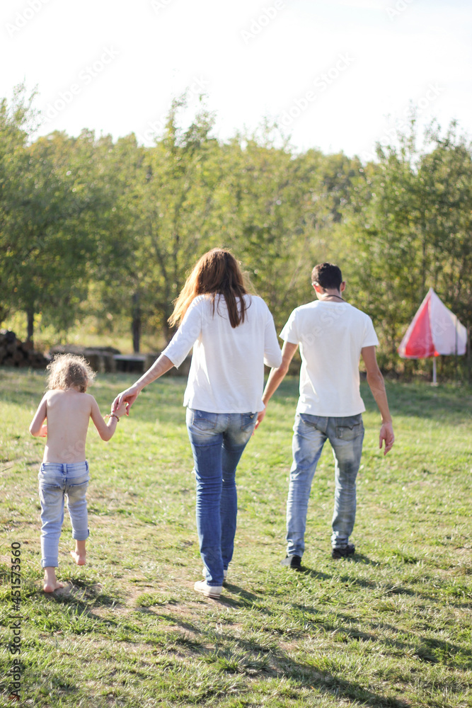 Fototapeta premium parent and child walking in park