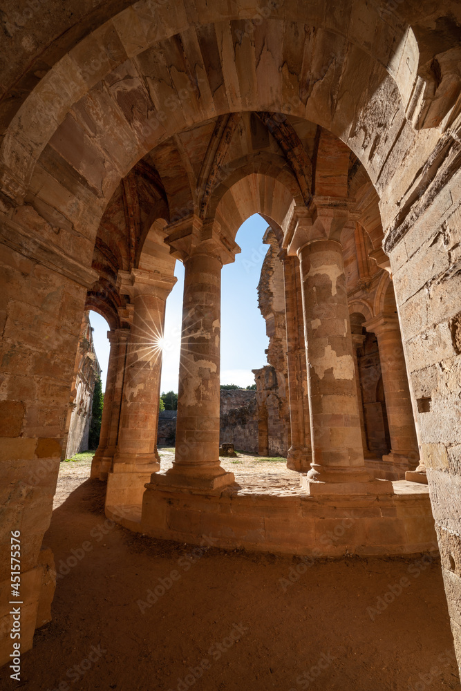 Old ruined monastery building against starry sun Old ruined monastery building against starry sun