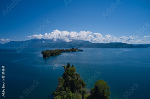 Magnificent aerial panorama of Isola del Garda, Lake Garda, Italy. Historic sites on Lake Garda. An island surrounded by the Italian Alps. Isola del Garda, Italy. Castle on an island in Italy.