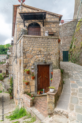 picturesque view of Sorano with old staircase, alley, underpass and plants in the Tuscan medieval village