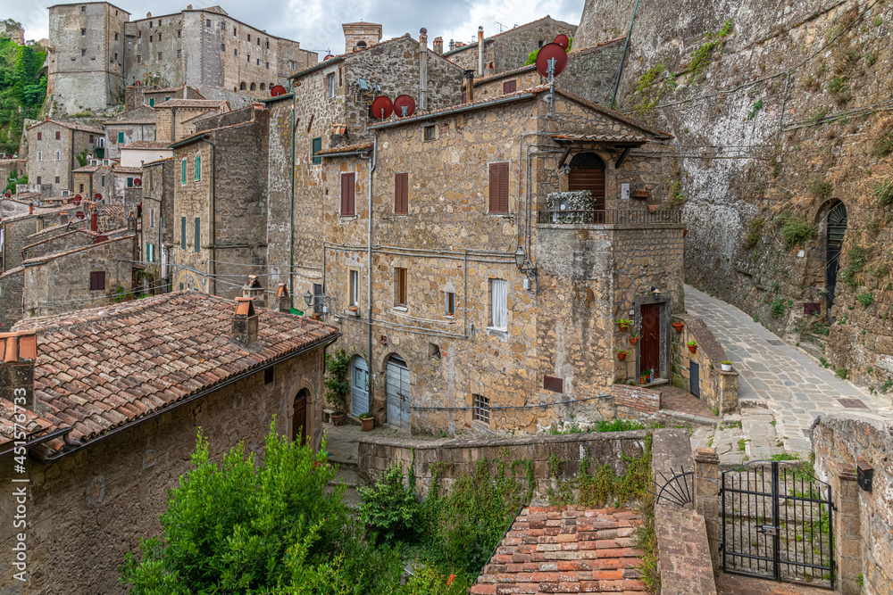 picturesque view of Sorano with old staircase, alley, underpass and plants in the Tuscan medieval village picturesque view of Sorano with old staircase, alley, underpass and plants in the Tuscan medieval village