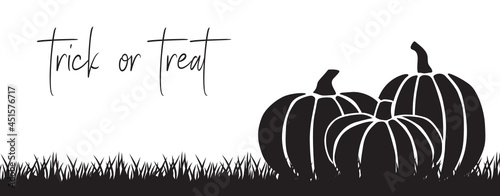 Trick or treat, typography with illustration of black pumpkins and grass
