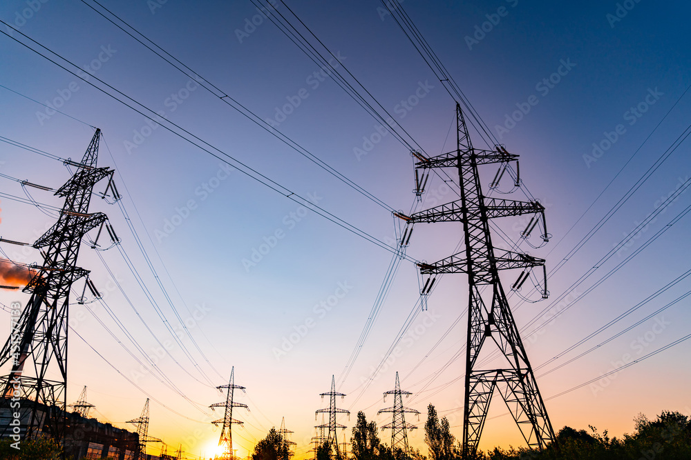 Power lines at the sunset background. High voltage pole mountain in the evening. High-voltage line, super cool sunset concept