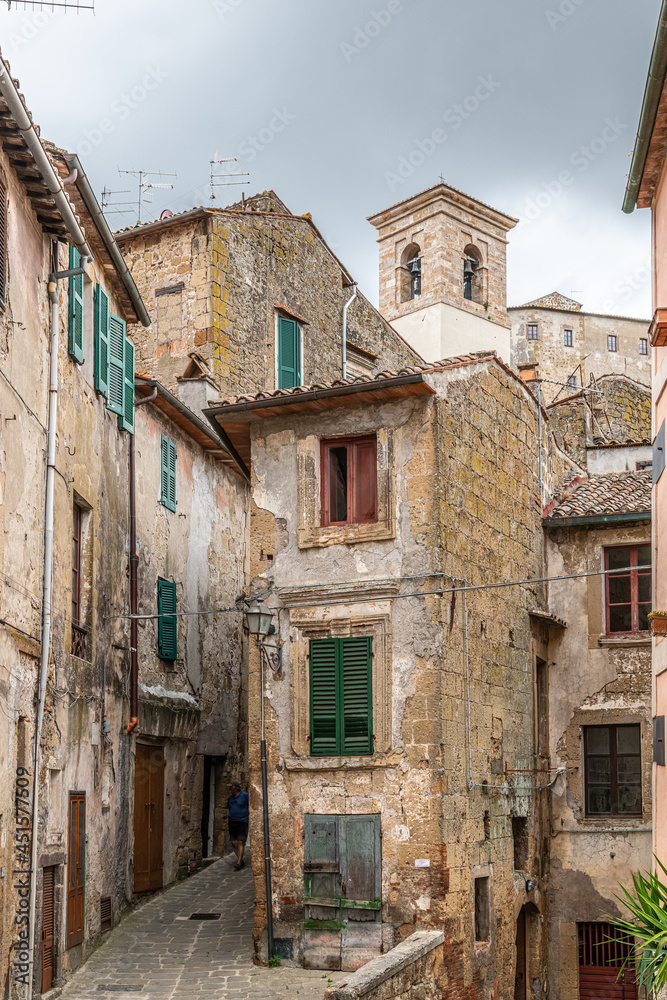 picturesque view of Sorano with old staircase, alley, underpass and plants in the Tuscan medieval village picturesque view of Sorano with old staircase, alley, underpass and plants in the Tuscan medieval village