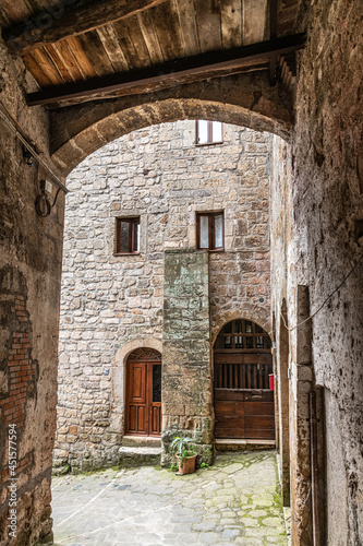 picturesque view of Sorano with old staircase, alley, underpass and plants in the Tuscan medieval village