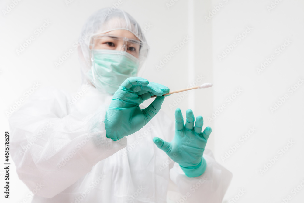 Doctor in protective suit PPE holding COVID-19 Nasal swab laboratory test. Medical worker performing Covid-19 test, taking nasal swab sample patient, PCR diagnostic, Rapid antigen test kit (ATK) Doctor in protective suit PPE holding COVID-19 Nasal swab laboratory test. Medical worker performing Covid-19 test, taking nasal swab sample patient, PCR diagnostic, Rapid antigen test kit (ATK)