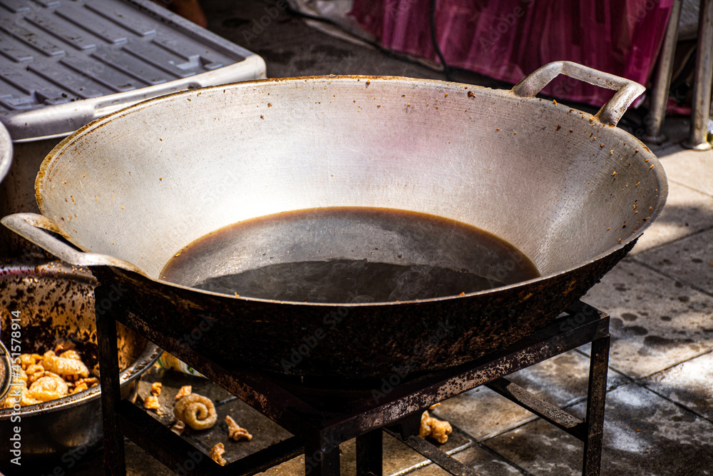 Old used cooking oil and look like black brown color in dirty iron pan.  Carcinogenic in food to cause cancer. Unhealthy lifestyle concept. Stock  Photo | Adobe Stock