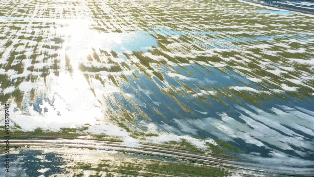 Aerial View Of Early Spring With Puddles Of Water In Fields. Top View Of Beautiful European Nature From High Attitude In Spring Season. Drone View. Bird's Eye View. late winter Aerial View Of Early Spring With Puddles Of Water In Fields. Top View Of Beautiful European Nature From High Attitude In Spring Season. Drone View. Bird's Eye View. late winter