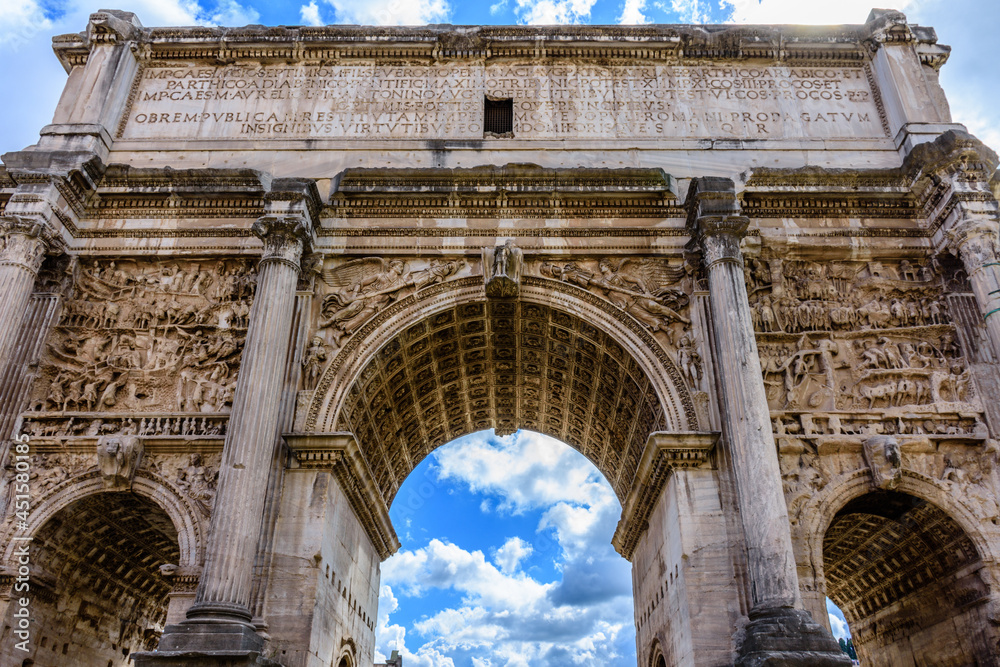 An imposing, ancient Roman arch at the Forum in Rome