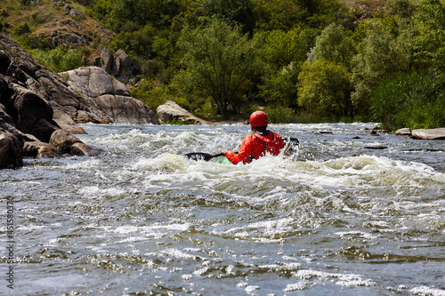 Whitewater kayaking down the rapids. Kayaker on the rough water © watcherfox