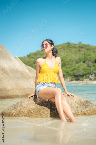 women portrait on the tropical beach wear yellow , rock beach, Crystal bay, Lamai , koh samui ,Suratthani ,thailand