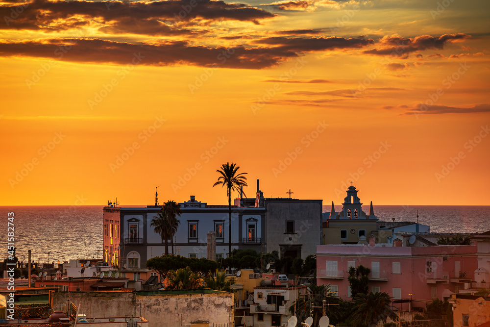 Beautiful sunset on the island of Ischia with view of the sea and the town hall
