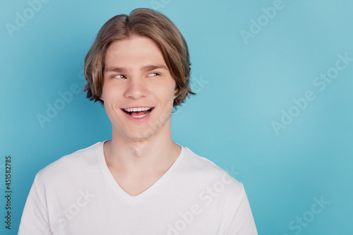 Photo of amazed guy isolated on blue background