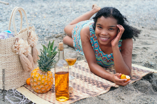 African American Woman drinking glass of wine outdoors © Hector Pertuz