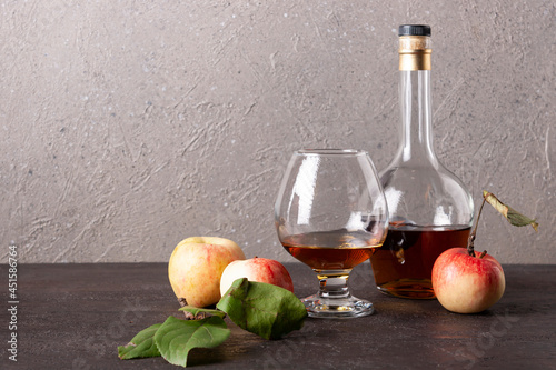 Canvas Print calvados in a bottle and glass on a wooden board space for text