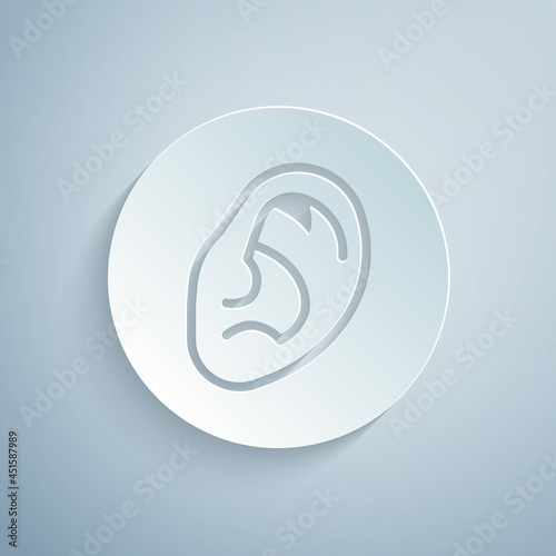 Paper cut Ear listen sound signal icon isolated on grey background. Ear hearing. Paper art style. Vector