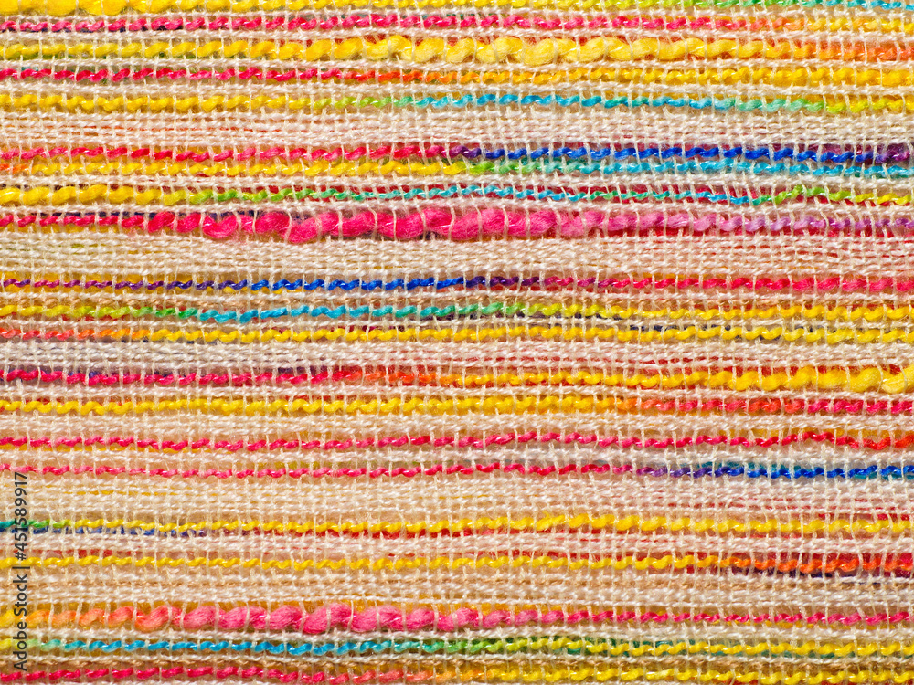 Multicolor striped bouclé cloth background, close-up