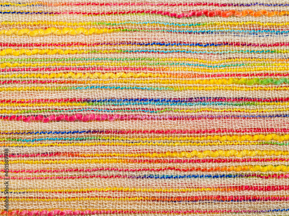 Multicolor striped bouclé cloth background, close-up