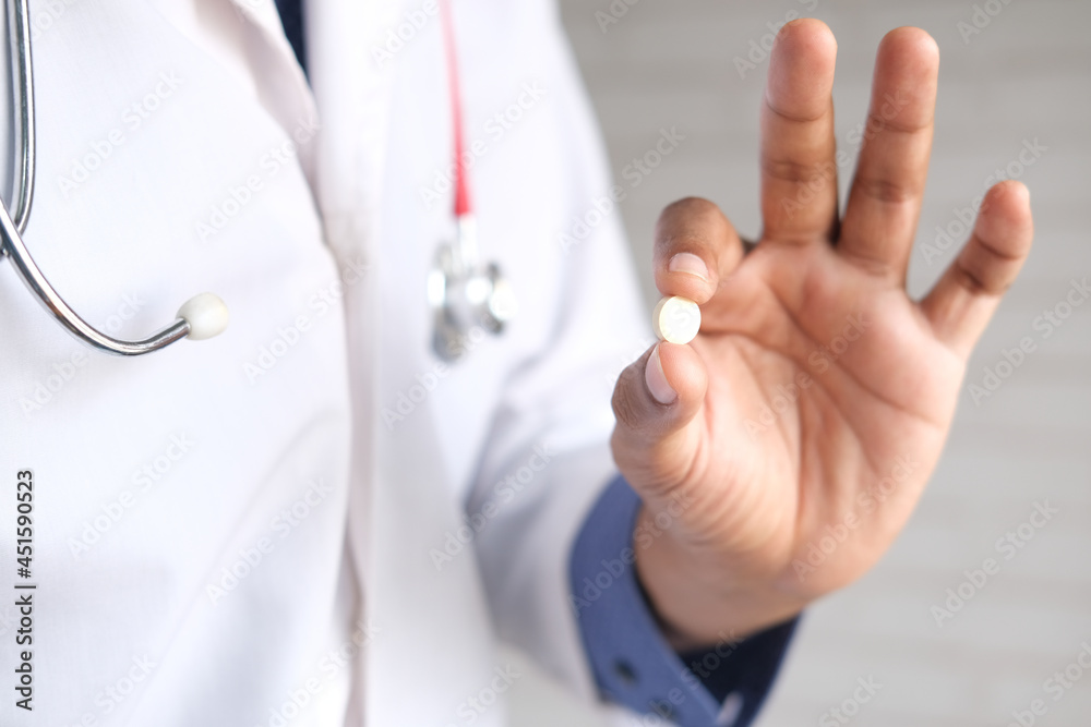 doctor holding medical pill on palm of hand doctor holding medical pill on palm of hand