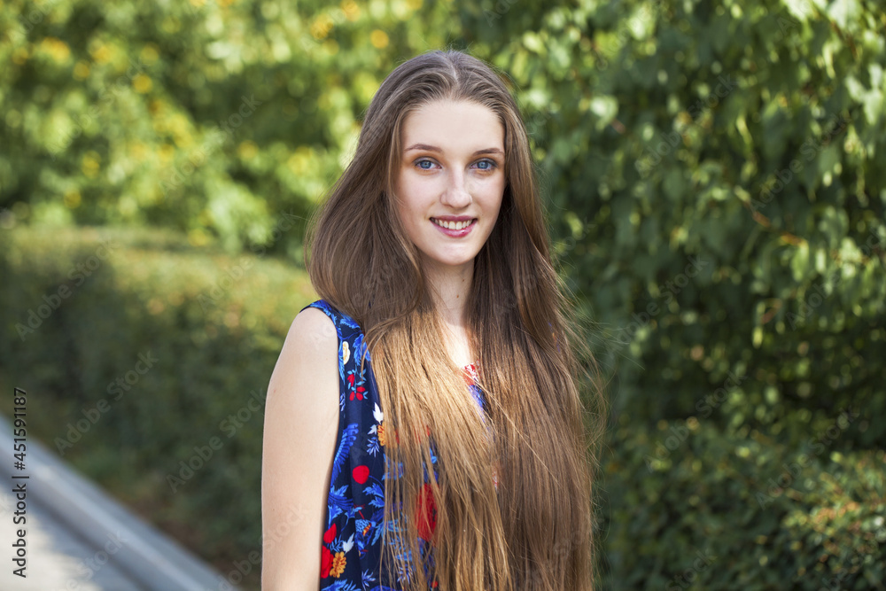 Portrait of a young beautiful brunette girl in summer park Portrait of a young beautiful brunette girl in summer park