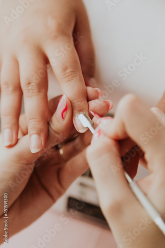 Manicurist , hands closeup. Professional manicure in beauty salon. Hygiene and care for hands. Beauty industry concept.
