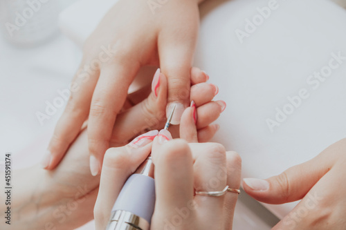Manicurist   hands closeup. Professional manicure in beauty salon. Hygiene and care for hands. Beauty industry concept.